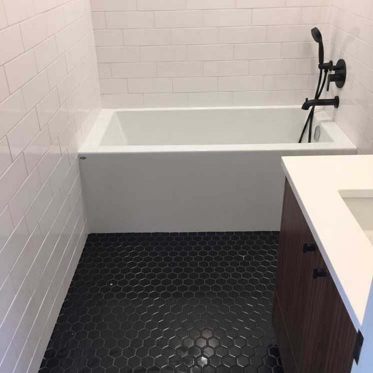 tub-surround-and-floor Bathtub Surround and Tile Floor Setting by Quinmor Tile